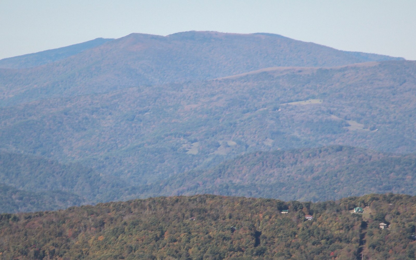 A grassy bald with the ridgeline running out behind it